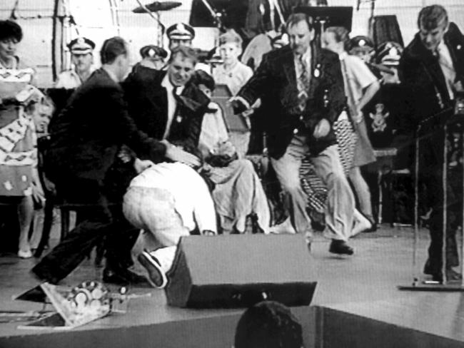 John Fahey (centre) and Clean Up Australia chairman Ian Kiernan rushed to shield Prince Charles after David Kang fired a starter pistol towards him during an Australia Day ceremony in Sydney in 1994.