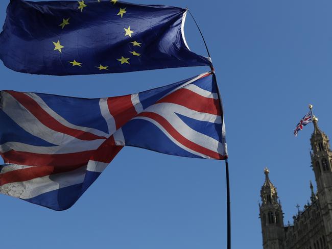 The flag of the European Union and the British national flags are flown on poles during a demonstration by remain in the EU outside spporters the Palace of Westminster in London, Wednesday, Feb. 27, 2019. British Prime Minister Theresa May says she will give British lawmakers a choice of approving her divorce agreement, leaving the EU March 29 without a deal or asking to delay Brexit by up to three months. (AP Photo/Alastair Grant)