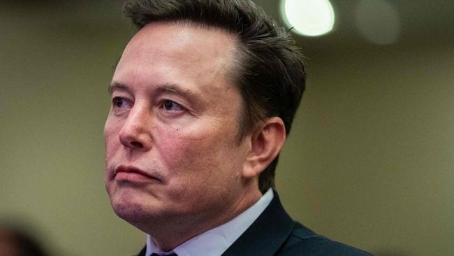 TOPSHOT - Elon Musk listens as US President-elect Donald Trump speaks during a meeting with House Republicans at the Hyatt Regency hotel in Washington, DC on November 13, 2024. (Photo by Allison ROBBERT / POOL / AFP)