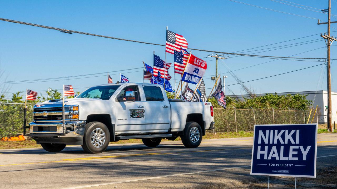 A flag-festooned truck in support of former President Donald Trump drives by a rally by Republican presidential candidate Nikki Haley in Columbia, South Carolina. (Photo by Brandon Bell / GETTY IMAGES NORTH AMERICA / Getty Images via AFP)