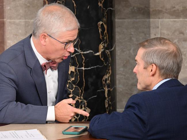 Speaker Pro Tempore Rep. Patrick McHenry (R-NC) who presides over the vote for Speaker of the House in the House of Representatives, speaks with Rep. Jim Jordan (R-OH) inside the House Chamber at the US Capitol in Washington, DC, on October 18, 2023. US lawmakers rejected hard-line conservative Jim Jordan's bid for speaker of the House of Representatives in the first round of voting October 18, 2023, entrenching a stalemate that has paralyzed Washington for two weeks. (Photo by Mandel NGAN / AFP)