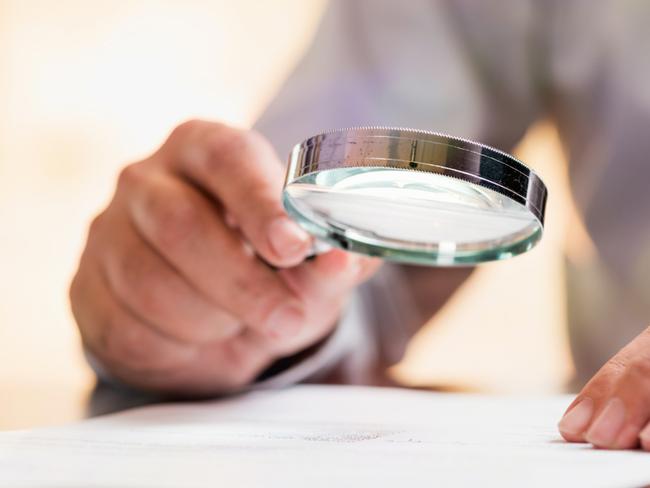 Businessman Reading Contract Details Before Signing