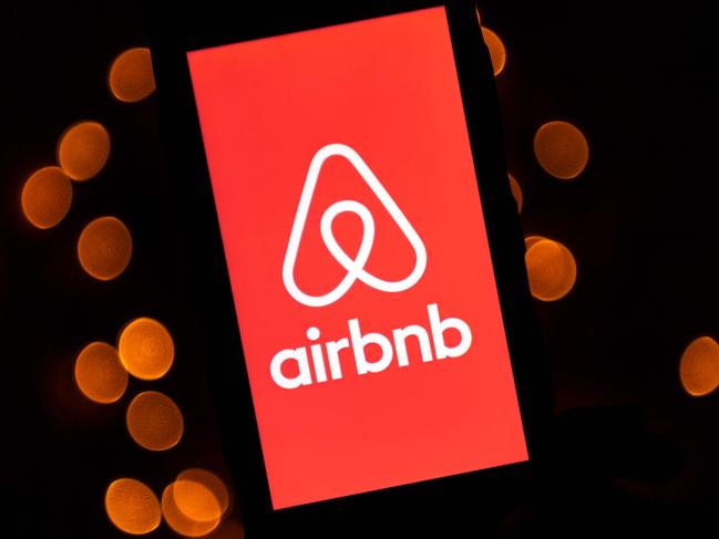 This illustration picture taken on November 22, 2019, shows the logo of the online lodging service Airbnb displayed on a smartphone in Paris. (Photo by Lionel BONAVENTURE / AFP)