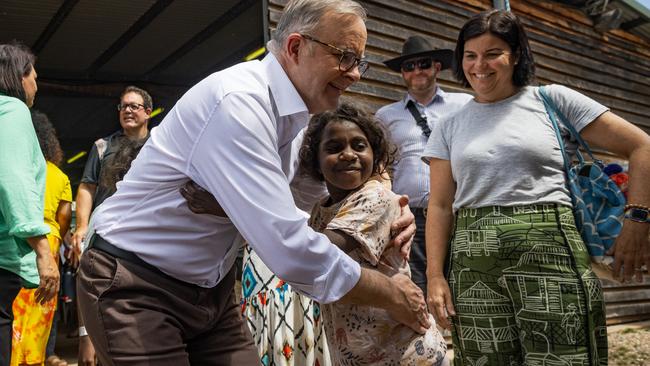 Prime Minister Anthony Albanese embraces a Yolngu child during Garma Festival in the Northern Territory where he spoke in favour of a Voice. Picture: Tamati Smith/Getty Images