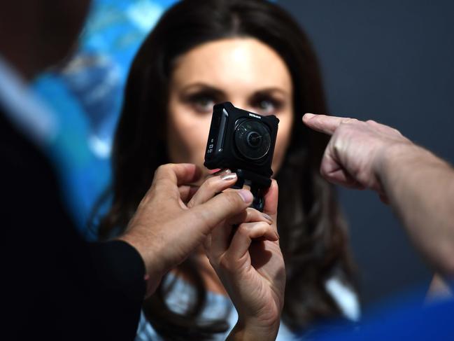 Visitors test Virtual Reality glasses at the Nikon stand at the Photokina trade fair in Cologne on September 20, 2016. The fair for the photographic and imaging sector, that is running from September 20 to 25, 2016, presents products from image capture, image processing and storage to image output. Photokina also includes a program of events with congresses, workshops, symposiums and photography exhibitions. / AFP PHOTO / PATRIK STOLLARZ