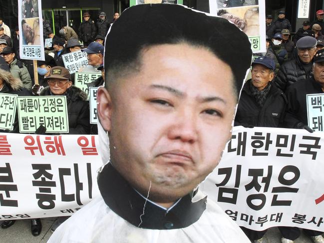 FILE - In this Tuesday, Dec. 17, 2013 file photo, a portrait of North Korean leader Kim Jong Un is displayed during an anti-North Korea rally marking the second anniversary of former North Korean leader Kim Jong Il's death in Seoul, South Korea. South Korea is continuing an escalating rhetorical battle on the Korean Peninsula, with an official saying rival North Korea 