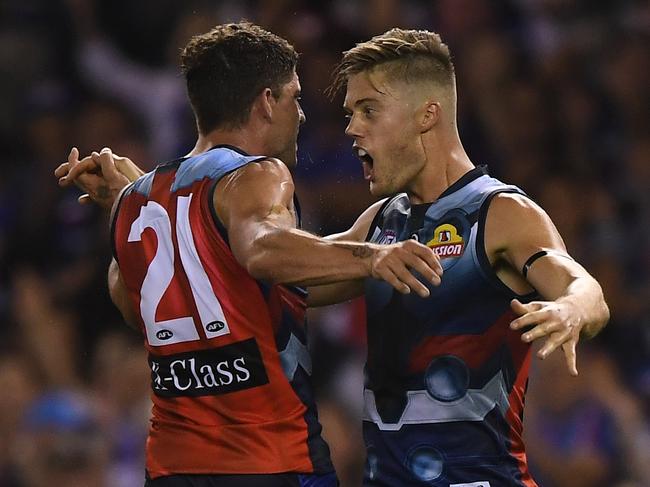 Tom Liberatore and Josh Schache of the Bulldogs react after Schache kicked a goal during the Round 1 AFL match between the Western Bulldogs and the Sydney Swans at Marvel Stadium in Melbourne, Saturday, March 23, 2019. (AAP Image/Julian Smith) NO ARCHIVING, EDITORIAL USE ONLY