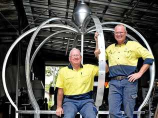 Electrician John Hough and Tony Blackadder from Grafton Ally Fabrications put the finishing touches to the new Jacaranda Queen Clocktower crown. Picture: Jenna Thompson