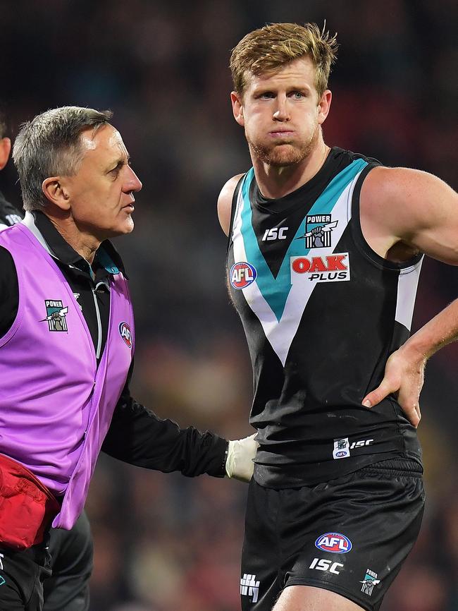 Tom Jonas shows some discomfort against Melbourne on Friday night. He will miss Saturday’s game against Carlton with a hamstring injury. Picture: Daniel Kalisz/Getty Images)