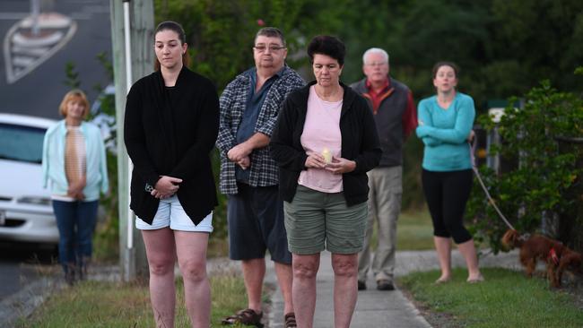 People stand outside their homes at dawn to commemorate Anzac Day in Brisbane, Saturday, April 25, 2019. Anzac Day is a national day of remembrance to commemorate the service and sacrifice of Australian and New Zealand service men and women. Due to COVID-19 restrictions marches and commemorative services have been banned for the first time in more than a century. (AAP Image/Dan Peled) NO ARCHIVING