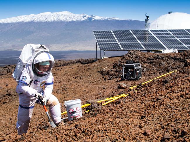 Martha Lenio collects a soil sample outside of the dome in which six scientists lived an isolated existence to simulate life on a mission to Mars, on the bleak slopes of dormant volcano Mauna Loa near Hilo on the Big Island of Hawaii. Picture: Neil Scheibelhut/AP