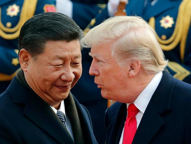 US President Donald Trump, right, chats with Chinese President Xi Jinping during a welcome ceremony at the Great Hall of the People in Beijing. Picture: Andy Wong