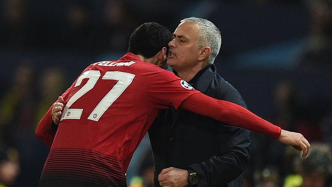 Manchester United's Belgian midfielder Marouane Fellaini (L) celebrates scoring his team's first goal with manager Jose Mourinho