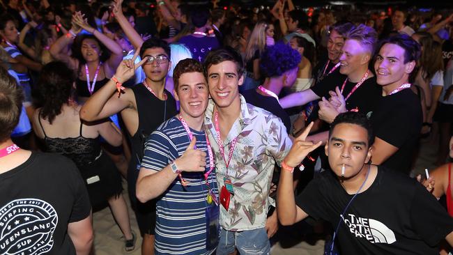 Matthew Rolls and Louis Caltabiano (centre) among graduates at Surfers Paradise last year. Picture: AAP Image/Richard Gosling