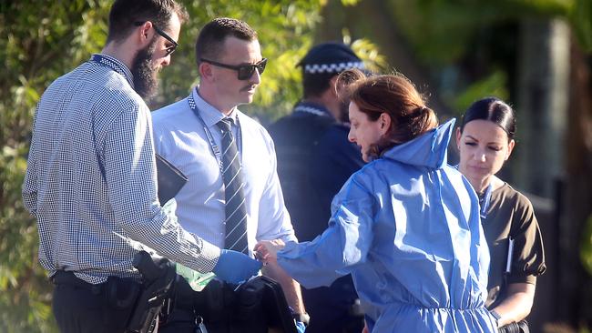 Detectives at the harrowing scene. Photo: AAP Image/Richard Gosling