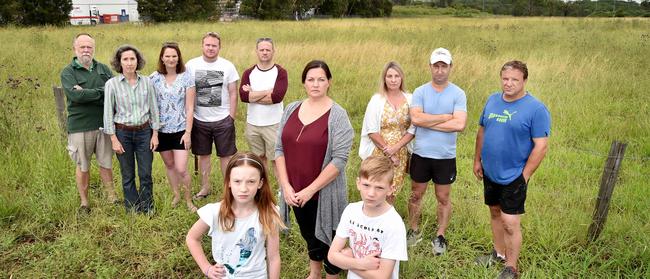 Concerned Mile End Rd residents (L-R) Rob &amp; Andrea McFarlane, Carol &amp; John Van De Maele, Emily Van De Maele, 8, Dr David Anger, Kelly Zammit, David Van De Maele, 11, Cayleen Gualterio, Michael Lambert &amp; Neil Poullos thought that plans for a bus depot had been withdrawn. Turns out they are back and bigger than ever. Picture: AAP Image / Troy Snook