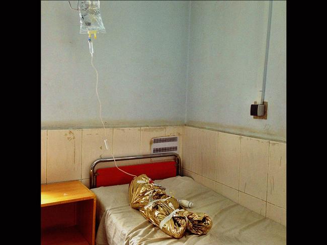 Second place - Andrew Quilty's 'Burns Victim': In Boost Hospital (run by Medicines Sans Frontiers) in the provincial capital of Helmand Province, Afghanistan, a young girl lies in an observation room after being burnt in an accident with an oil lamp. Heat blankets are used to protect the body from cooling down to dangerously low temperatures as it attempts to deal with the burns. Picture: Head On Head On Photo Festival Mobile Prize 2014