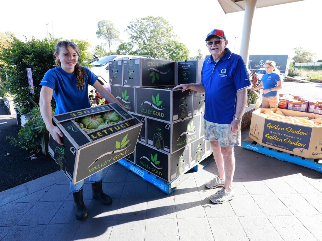 Global Care volunteers Arzia Williamson and Mick Brooks unload a pallet of lettuces delivered by Foodbank on Thursday morning. Picture: Scott Calvin