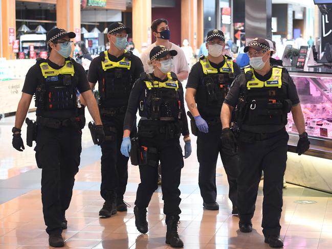 Police patrol through a shopping centre after an anti-lockdown protest in the Melbourne suburb of Chadstone. Picture: AFP.