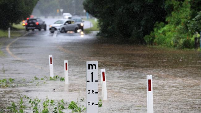 Queensland uniformed Police block the road on Tallebudgera Connection Road Tallebudgera at the back of Currumbin Creek after torrential rain over night caused the creek to break its banks. NCA NewsWire / Scott Powick