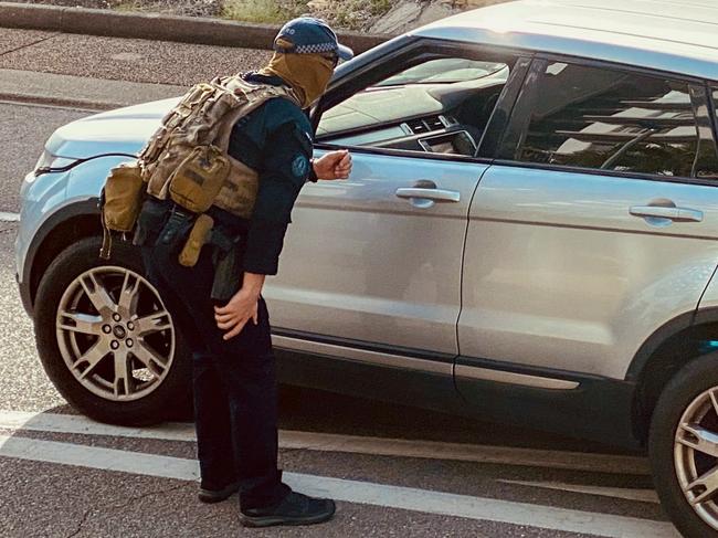 Heavily-armed police officers swarmed on a Cullen Bay Crescent home where they arrested a 53-year-old man over alleged serious harm offences. Picture: Supplied