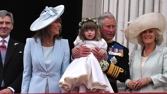 Prince Charles holds up Eliza, then 3. Picture: AFP Photo/WPA Pool/John Stillwell