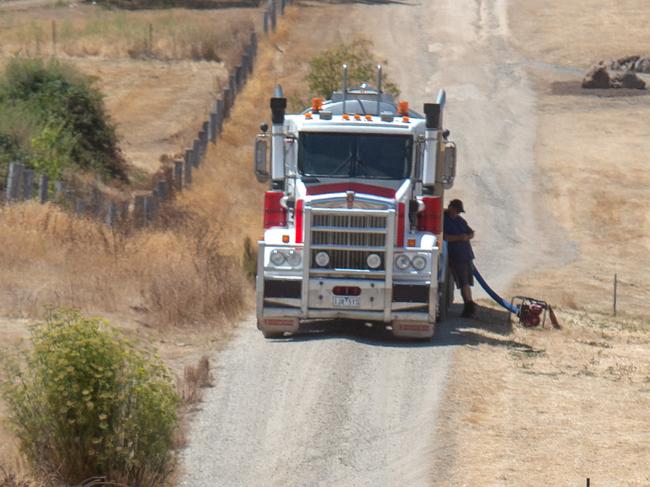 Hepburn Springs Bushfire. Aerial fire bombing on the fire. A CFA truck races back to the fire after filling up with water from a tanker.Picture: Jay Town