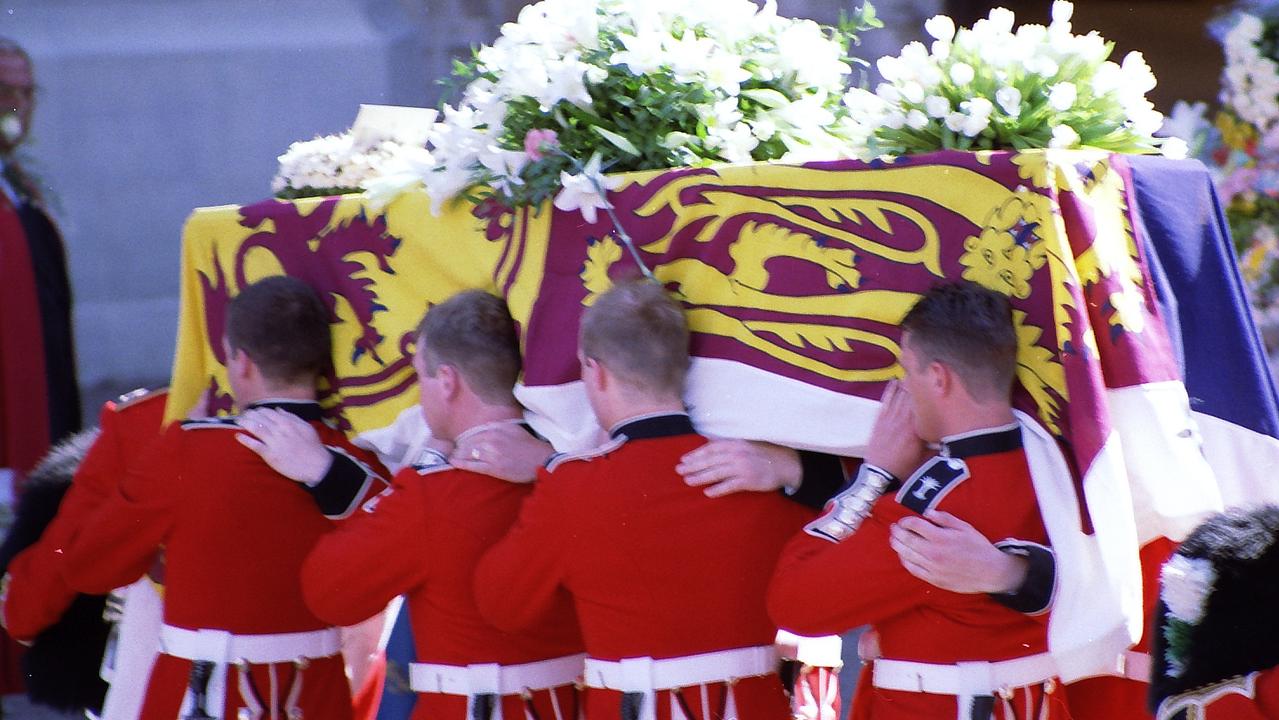 Draped in a royal flag, Princess Diana's coffin is carried at her funeral.