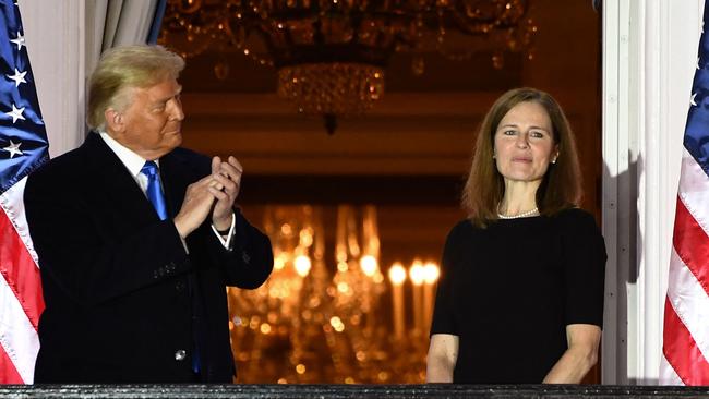 Donald Trump applauds Judge Amy Coney Barrett on the Truman Balcony after she was sworn in as a US Supreme Court Associate Justice. Picture: AFP.