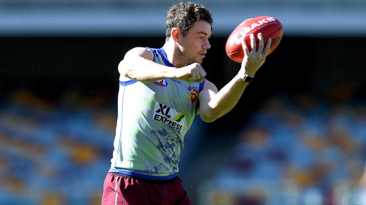 Lachie Neale handballs during a Brisbane Lions training session at The Gabba.