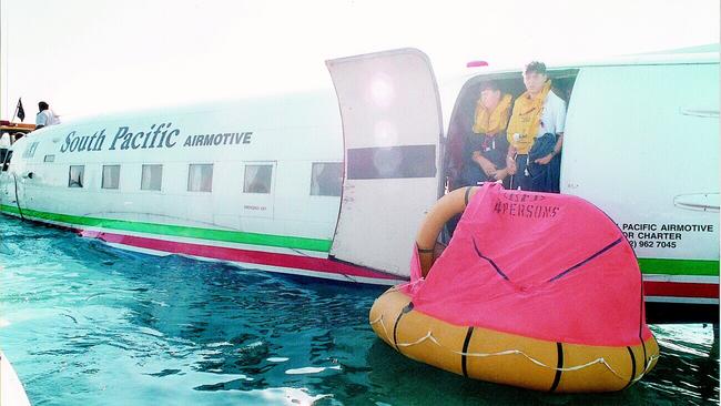 Passengers including Sydney schoolboys calmly escape the ditched DC3. Picture: Chris Pavlich