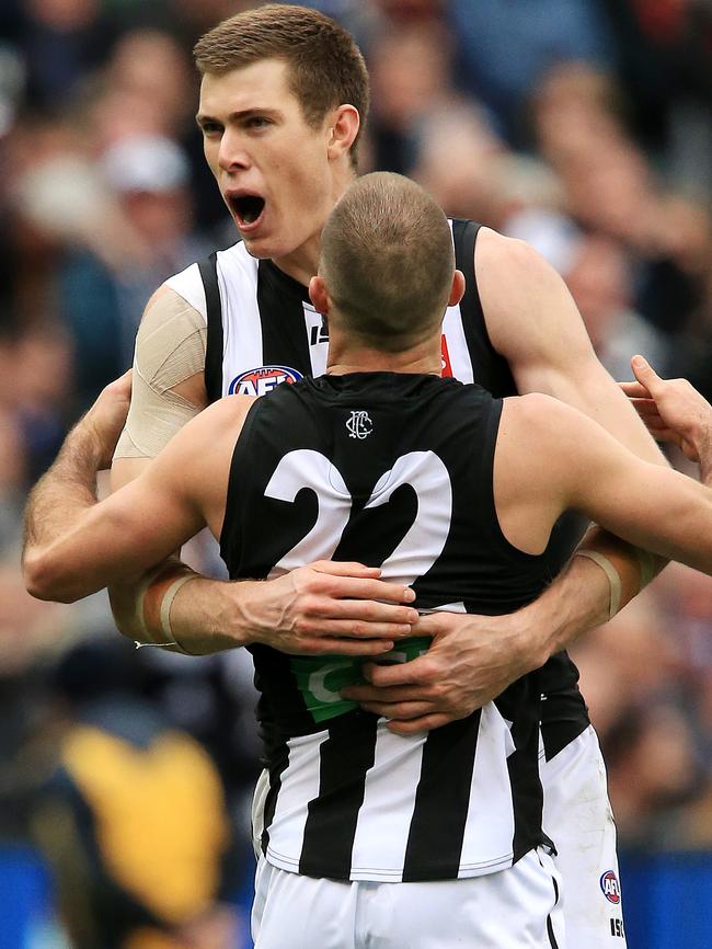 Cox celebrates a final-quarter goal with Steele Sidebottom. Picture: Mark Stewart