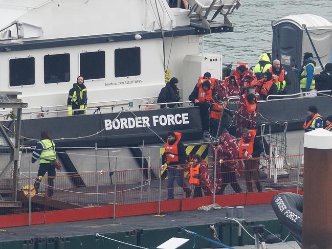 DOVER, ENGLAND - JANUARY 17: Migrants are brought ashore after being picked up in the English Channel by a Border Force vessel on January 17, 2024 in Dover, England. The first boats of 2024 carrying migrants across the English Channel from France began arriving in the South of England on 13 January. Just a day later five migrants drowned off the coast of France attempting to cross. This week, the UK parliament is debating the government's plans to send migrants who arrive by small boats to Rwanda.  (Photo by Dan Kitwood/Getty Images)