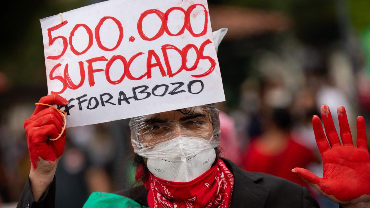 A demonstrator in Manaus on Saturday highlighting the number if deaths in Brazil (Photo by Michael Dantas / AFP)