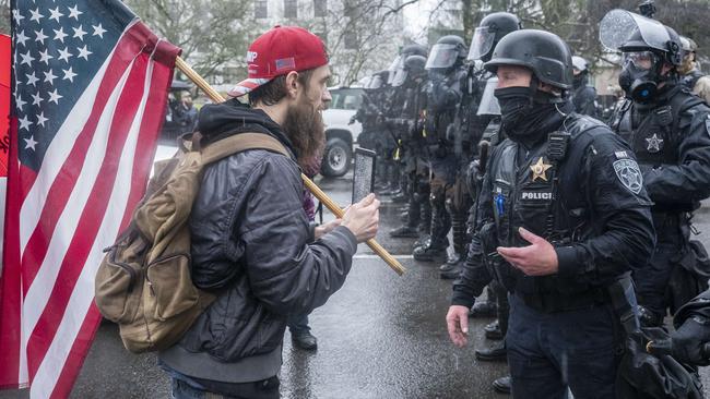 A Trump supporter speaks with riot police during a protest. Picture: Getty Images