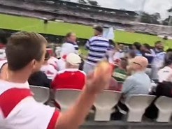 Screen grabs of an NRL  Dragons supporter who purchased a meat pie and threw it at a Bulldog's  supporter at the match. , , Source - Facebook: https://www.facebook.com/watch/?v=3915252775469020, ,