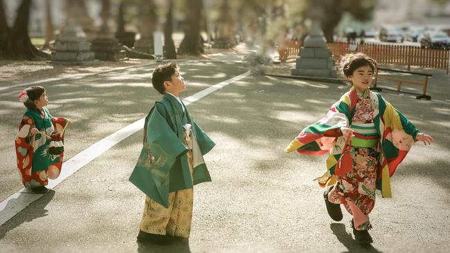 Children in traditional dress celebrating Shichi-­go-san festival at a Shinto shrine.