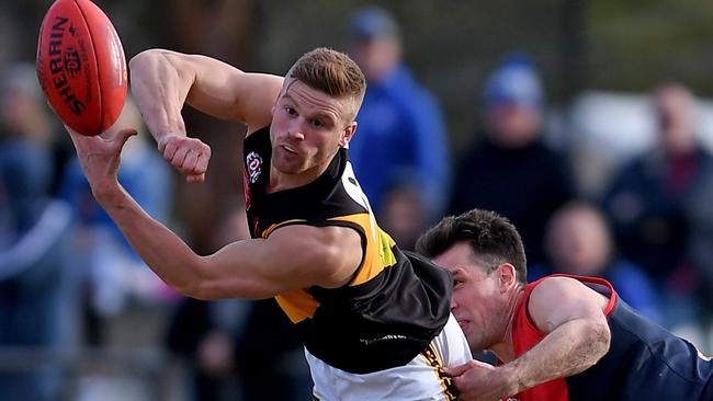 Westmeadow star Dean Clare fires off a handball. Picture: Andy Brownbill