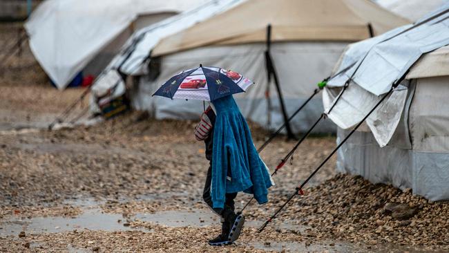 A child holds an umbrella in the Al Roj detention camp in northeast Syria in 2021. Picture: AFP