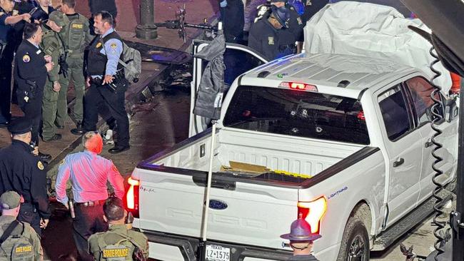 Police and investigators beside the vehicle driven by Shamsud-Din Jabbar in his attack on revellers in New Orleans.