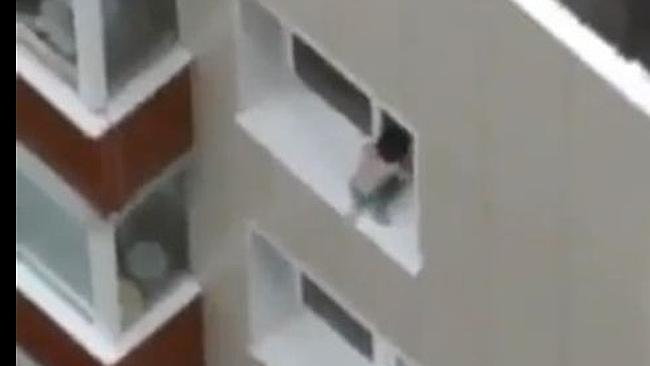 Baby walks along window ledge of high-rise building three times in ...