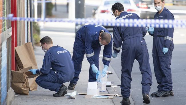 Forensic police examine outside Love Machine after a shooting.