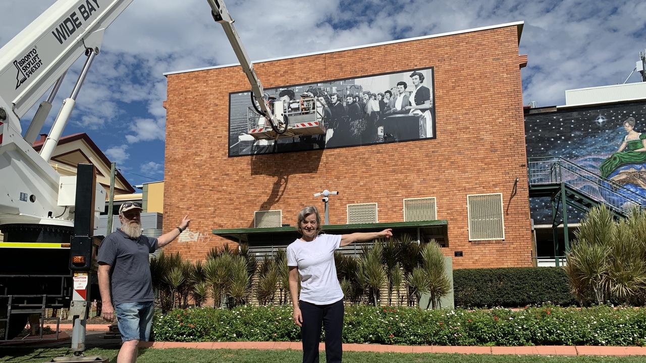 (L) Mural Project volunteer Rai Whitten and co-founder Deb Hannam in front of two murals, (L) The Exchange which is currently being repaired and the mural Our World. Photo: Stuart Fast