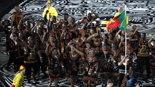 Eleven members of the Cameroon team — pictured marching into Carrara Stadium for the opening ceremony of the Commonwealth Games — are believed to be among the 19 who failed to return home.