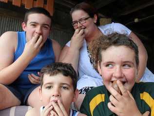 Cassie Stone and her children Jackson, Chad and Chonteal share a Kinder Surprise in honour of Robert Agius. Picture: Jarred Sferruzzi