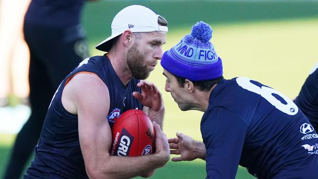 Sam Docherty, left, is tackled by teammate Kade Simpson at Ikon Park. Picture: Michael Dodge/AAP