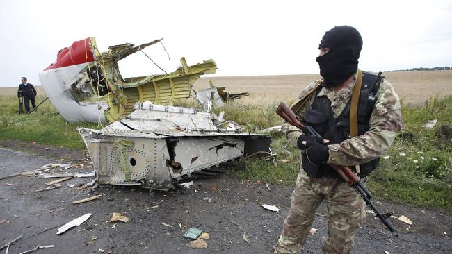 Too risky ... a pro-Russian separatist stands at the crash site of Malaysia Airlines flight MH17. Picture: Reuters