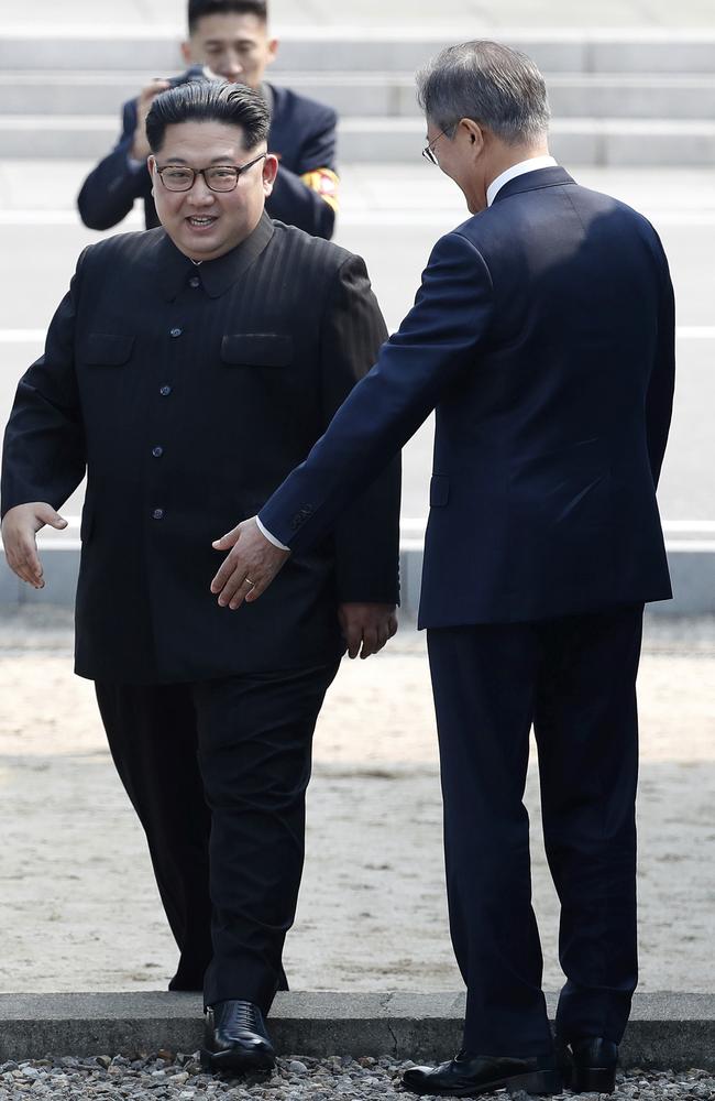 North Korean leader Kim Jong Un, left, crosses the military demarcation line to meet with South Korean President Moon Jae-in. Picture: AP