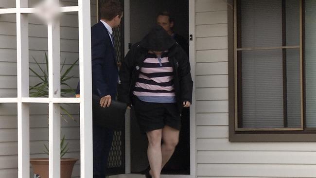 Emma Elizabeth Arnold, 29, is led away by detectives after being arrested at her St Marys home this morning. Picture: NSW Police