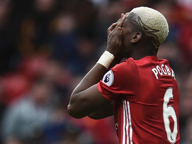 Manchester United's French midfielder Paul Pogba reacts after failing to convert a late chance during the English Premier League football match between Manchester United and Bournemouth at Old Trafford in Manchester, north west England, on March 4, 2017. The game finished 1-1. / AFP PHOTO / Oli SCARFF / RESTRICTED TO EDITORIAL USE. No use with unauthorized audio, video, data, fixture lists, club/league logos or 'live' services. Online in-match use limited to 75 images, no video emulation. No use in betting, games or single club/league/player publications. /